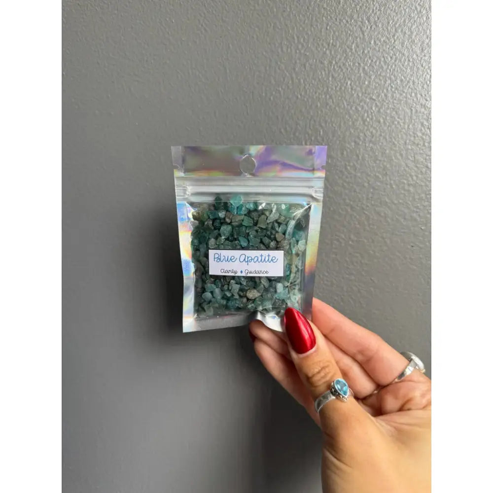 Silver opalite chip beads in bag with red nail polish for crafts