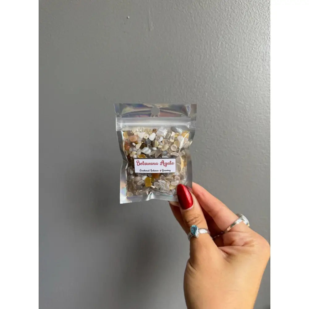 Clear plastic bag of premium crystal chip stones with white gold floral design