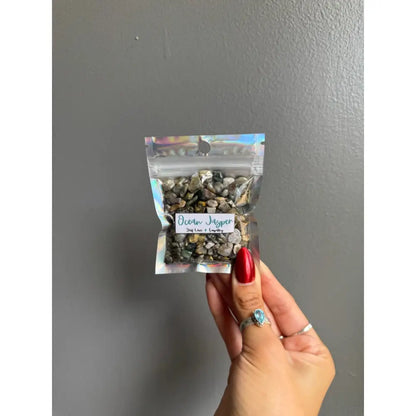 Clear plastic bag of multicolored beach jasper chip stones for crafts