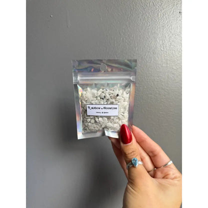 Clear plastic bag of premium white and black crystal chip stones for crafts