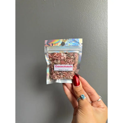 Pink white speckled shadow beads in bag with rainbow accents for crafts