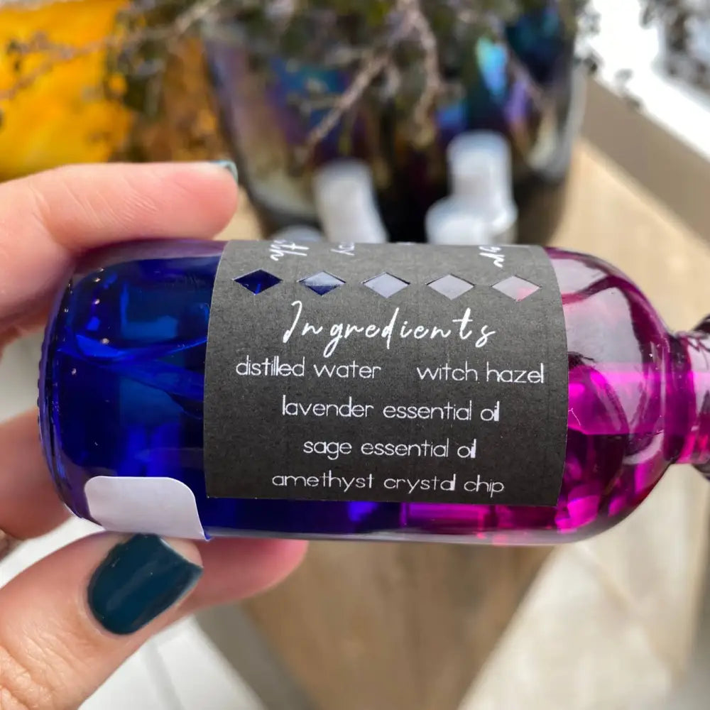 Cobalt blue bottle of Amethyst Crystal Cleansing Spray with purple liquid