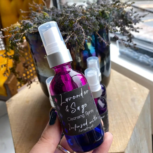 Lavender and sage aura cleansing spray in purple glass bottle