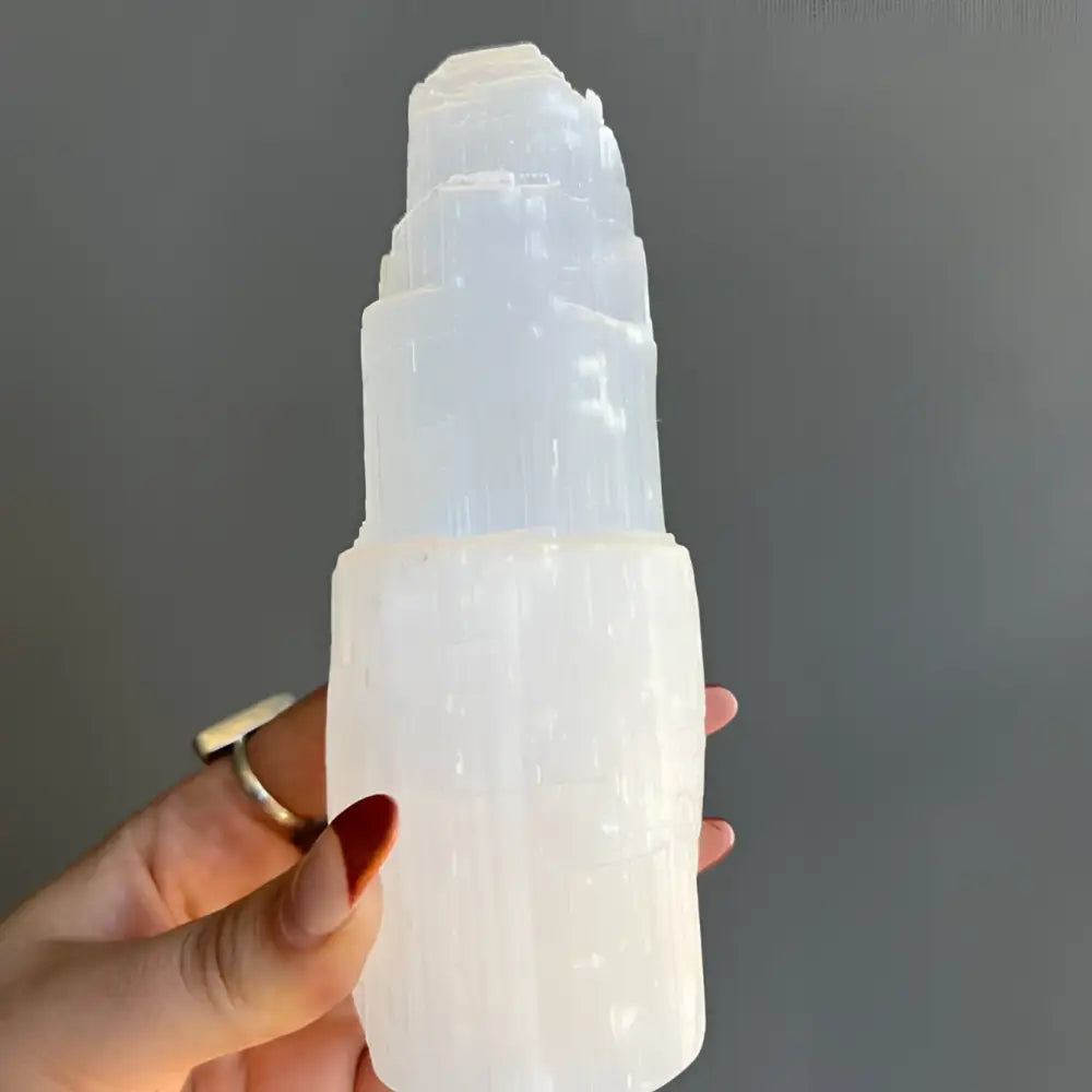 Moroccan selenite tower: white crystal with stacked layers and pointed top