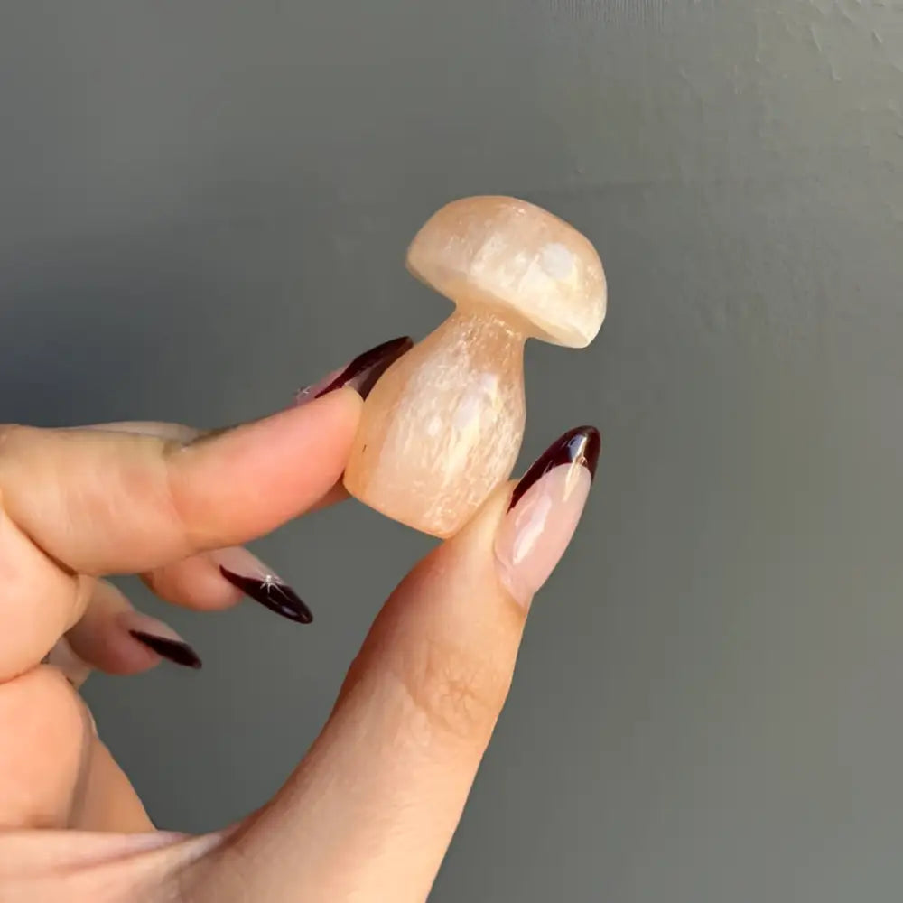 Glossy cream Moroccan Selenite mushroom soap with black nail polish