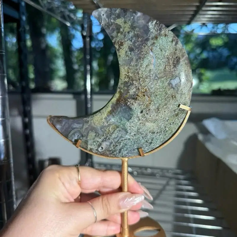 Moon-shaped Moss Agate figurine mirror with gold handle and green patina on stand