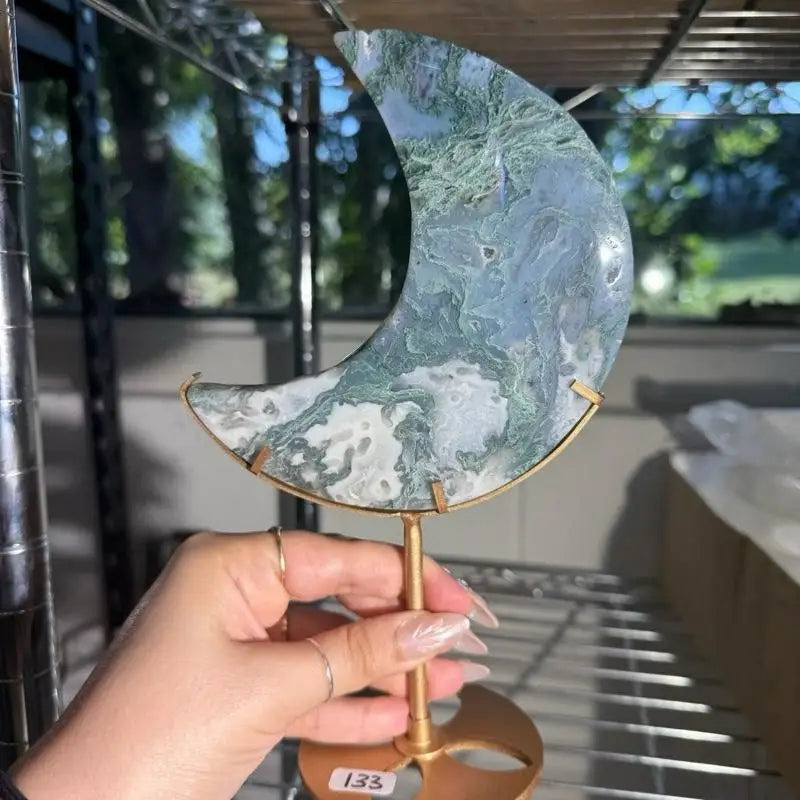 Moss agate moon-shaped slice on gold stand figurine
