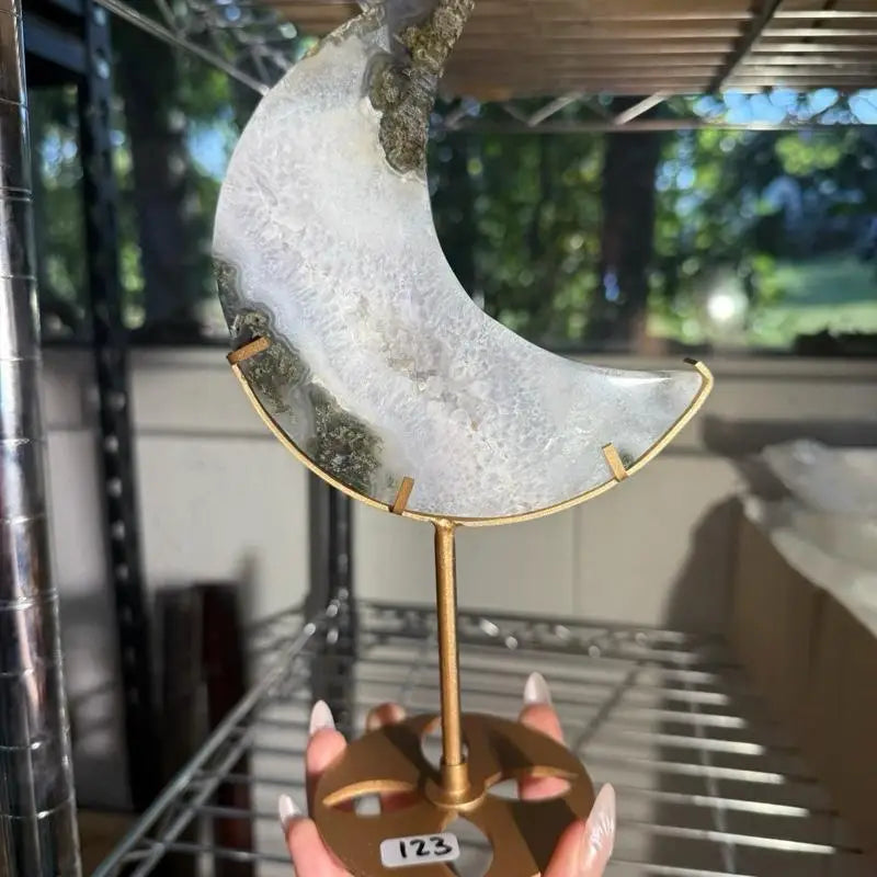 Moss agate moon figurine slice on gold stand