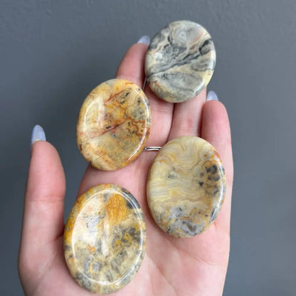 Yellow and brown marbled stone worry pendants, 2 inches natural