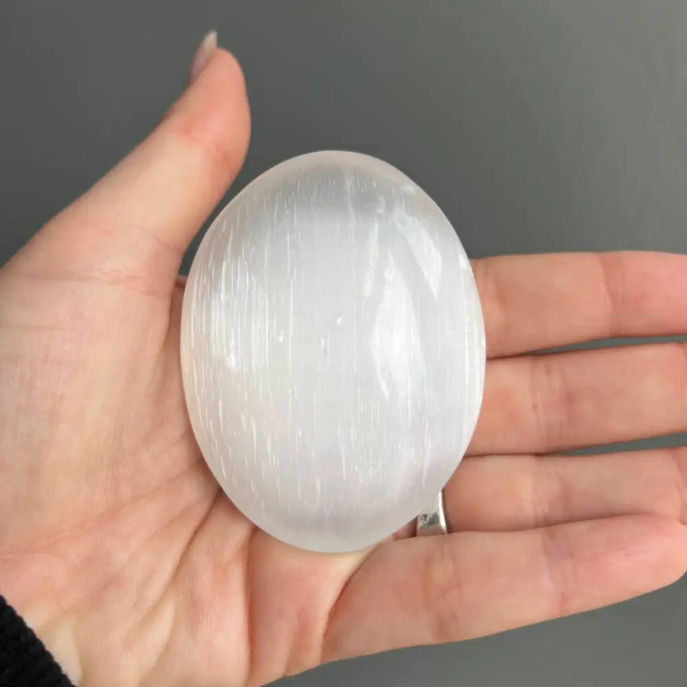 White selenite egg crystal pendant necklace on Moroccan gypsum palm stone