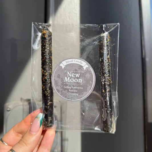 Black and green speckled New Moon ritual candles in clear packaging