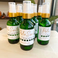 Palo Santo cleansing spray with clear quartz in 2oz green glass bottle and gold cap