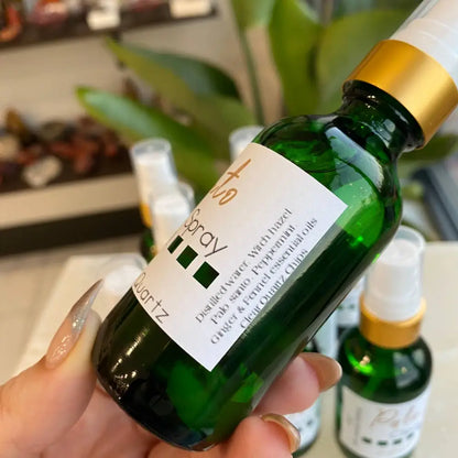 Green Palo Santo spray in 2oz glass bottle with gold cap