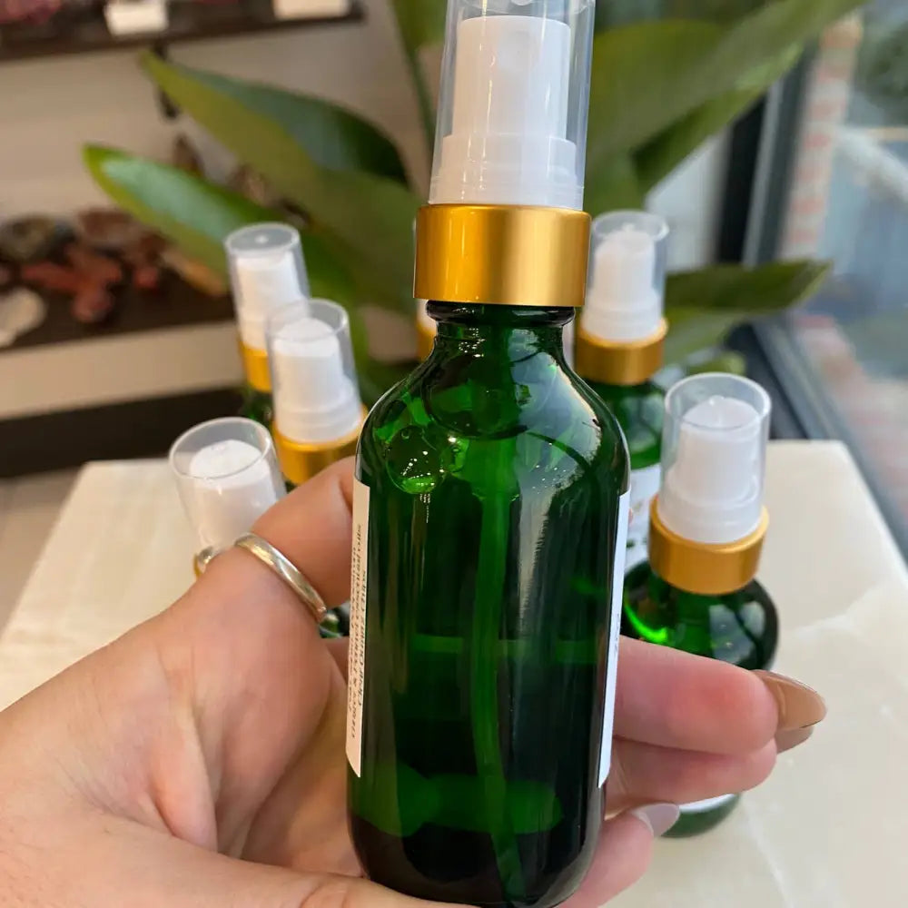 Green Palo Santo spray in 2oz glass bottle with gold cap