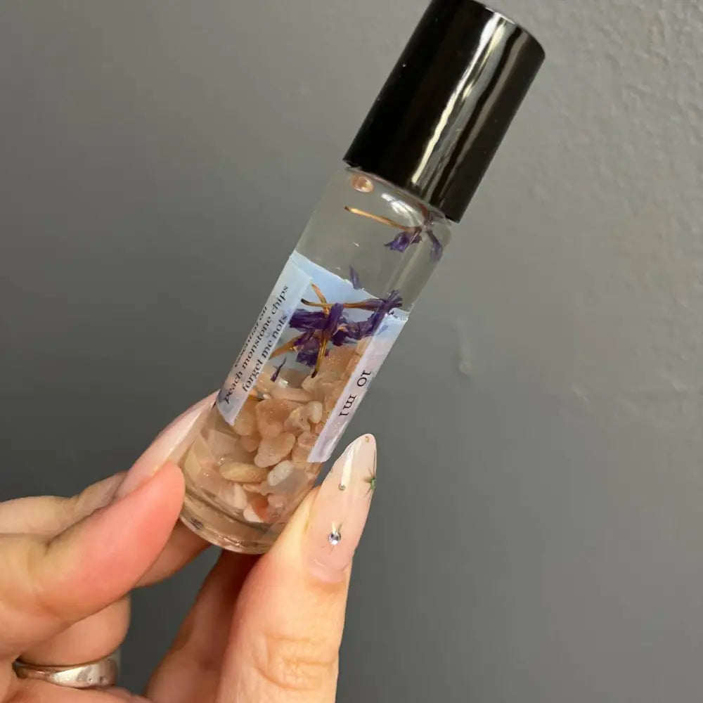 Peach Moonstone crystal perfume roller with lavender scent and dried petals