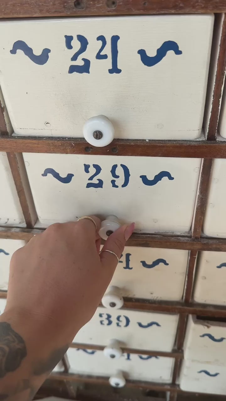 Packing a Mystery Crystal Box order from the numbered drawer cabinet