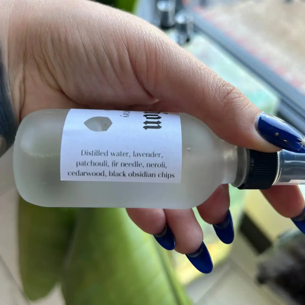 Frosted glass bottle of Protection Cleansing Spray with black cap