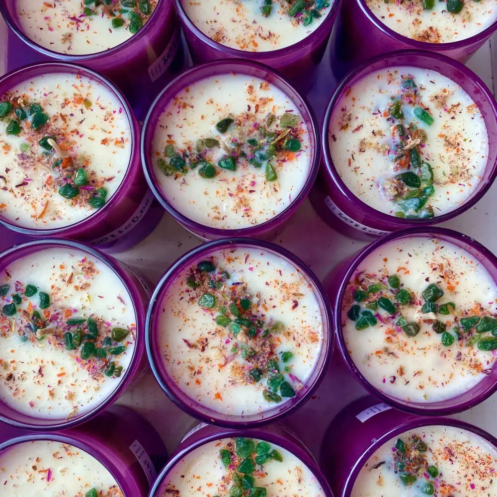 Purple ceramic bowls of creamy herb soup with chili flakes, soy wax candle scent