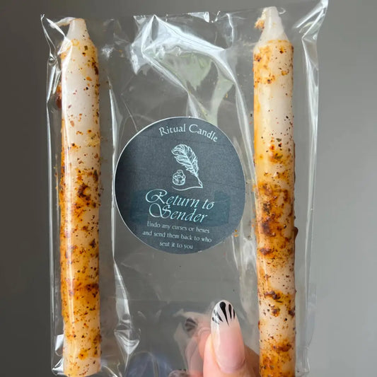 White taper candles with orange speckles in Return to Sender pack of two