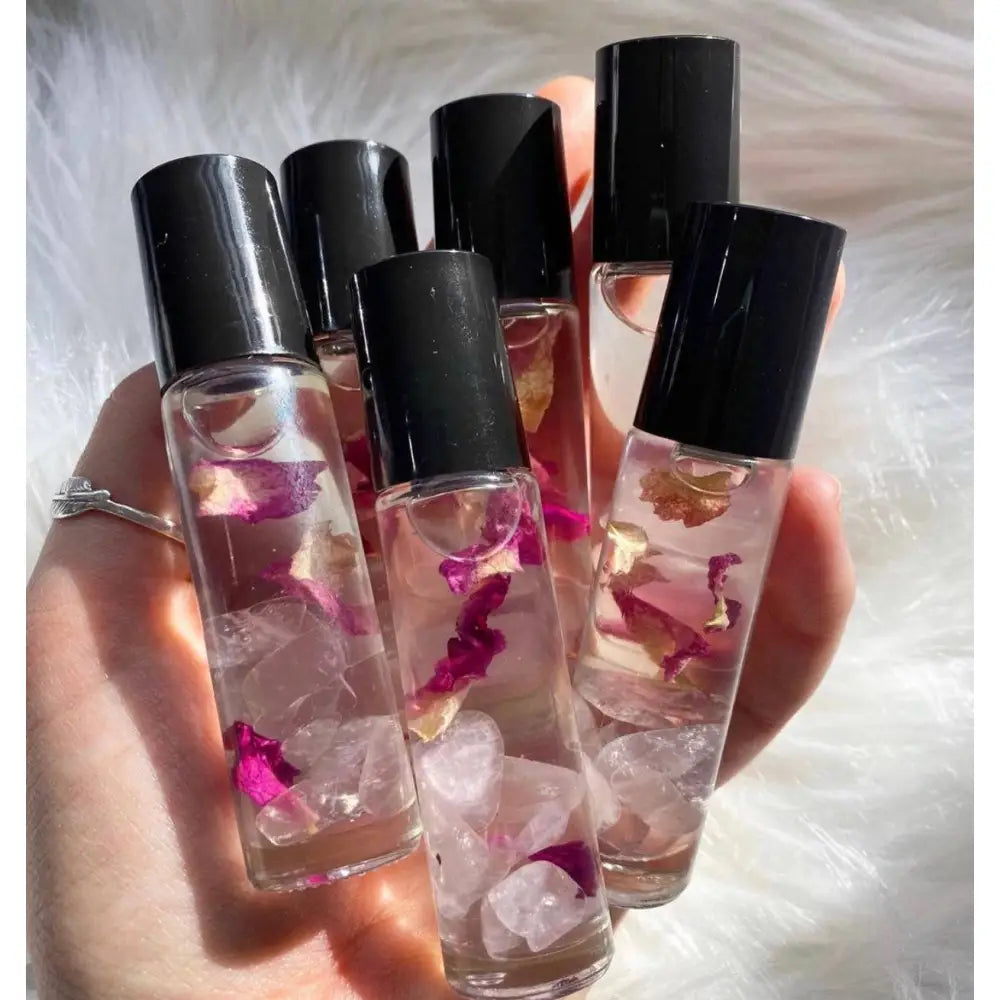 Rose quartz crystal perfume roller in clear glass bottle with black cap
