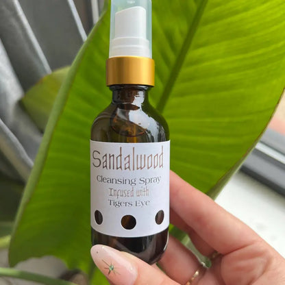 Sandalwood and vanilla cleansing spray in amber bottle with tigers eye accents