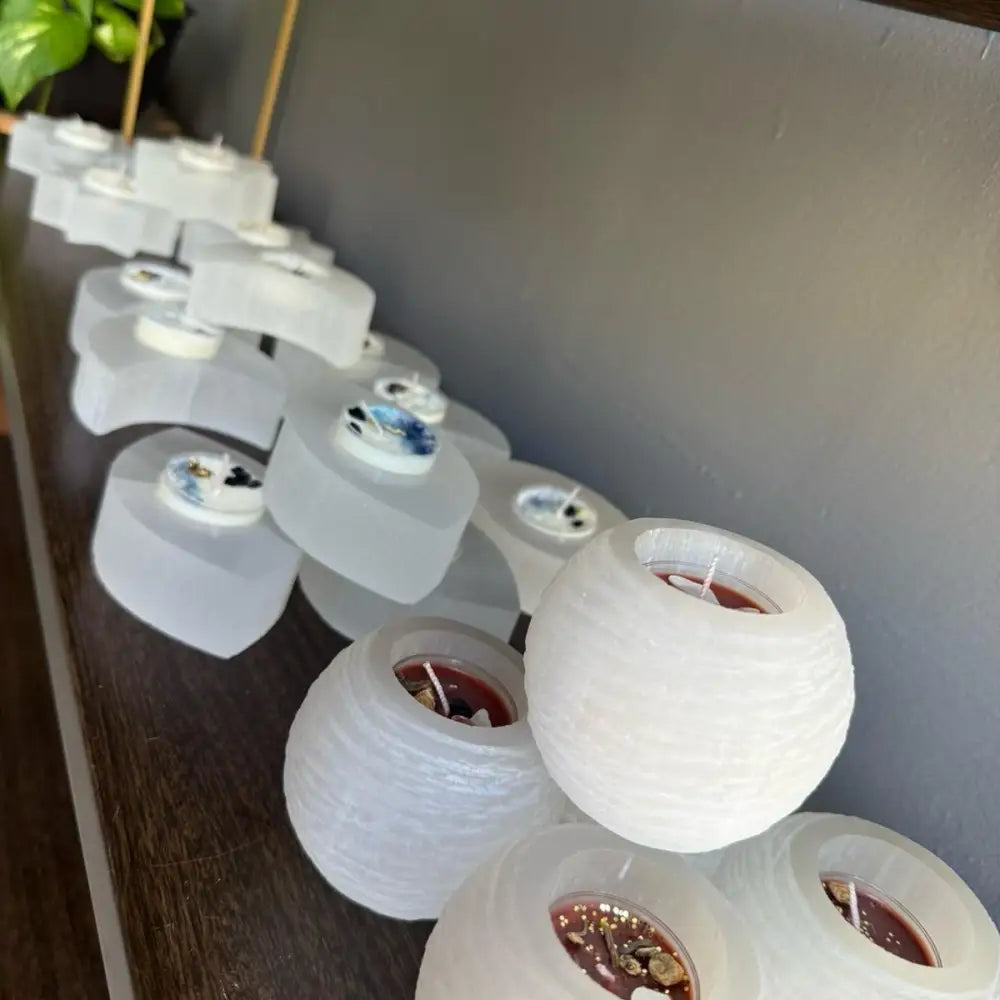 Selenite candle holder with white paper lantern and red wax for calming energy