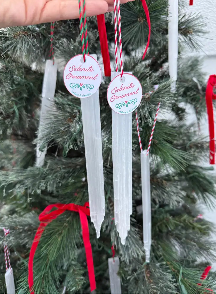 White selenite icicle ornament with red string and celebrate Christmas label