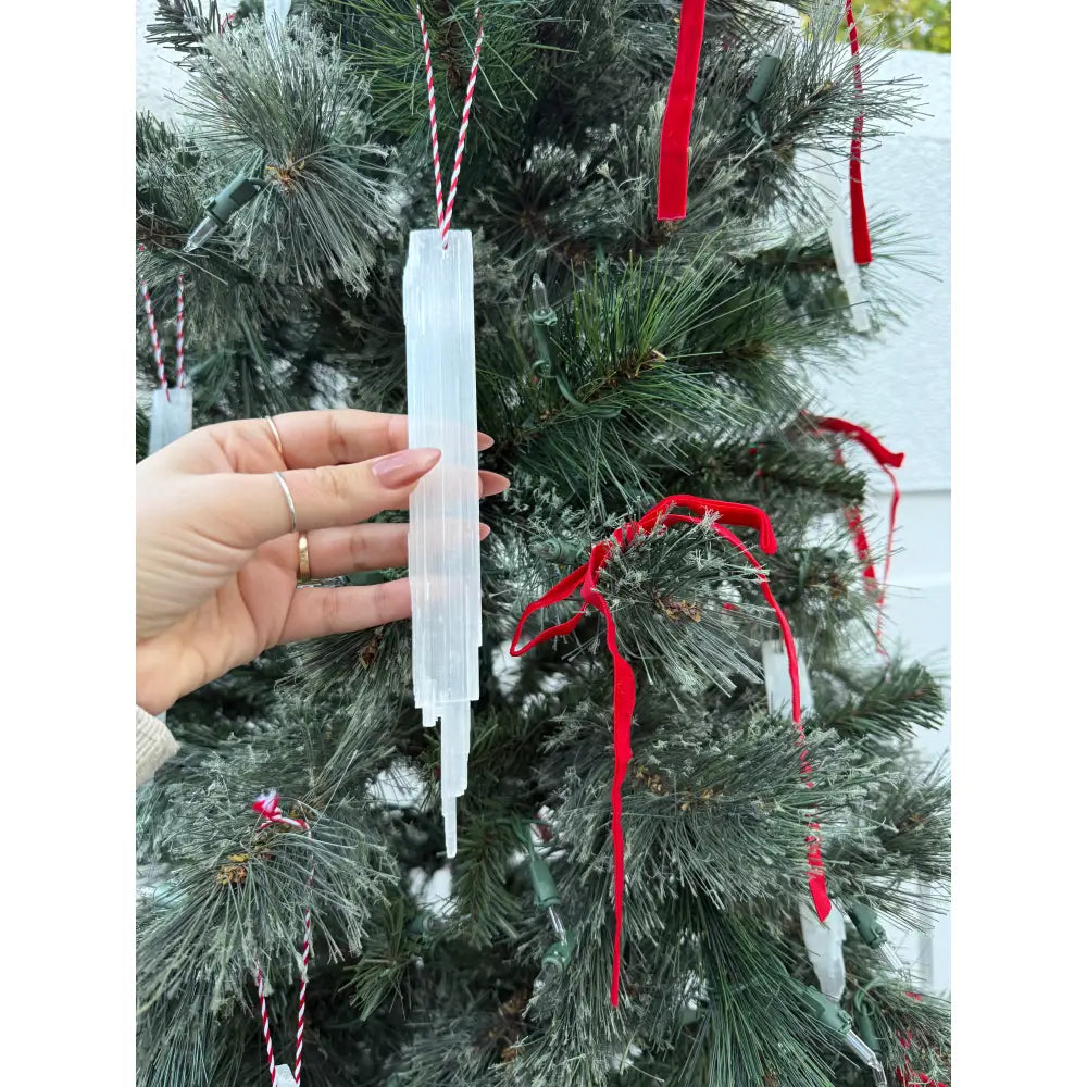 White selenite icicle ornament with red ribbon and silver accents