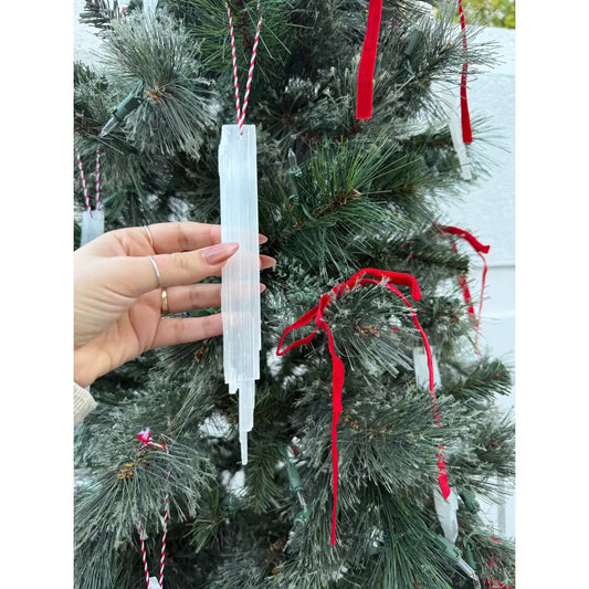 White selenite icicle ornament with red ribbon and silver accents