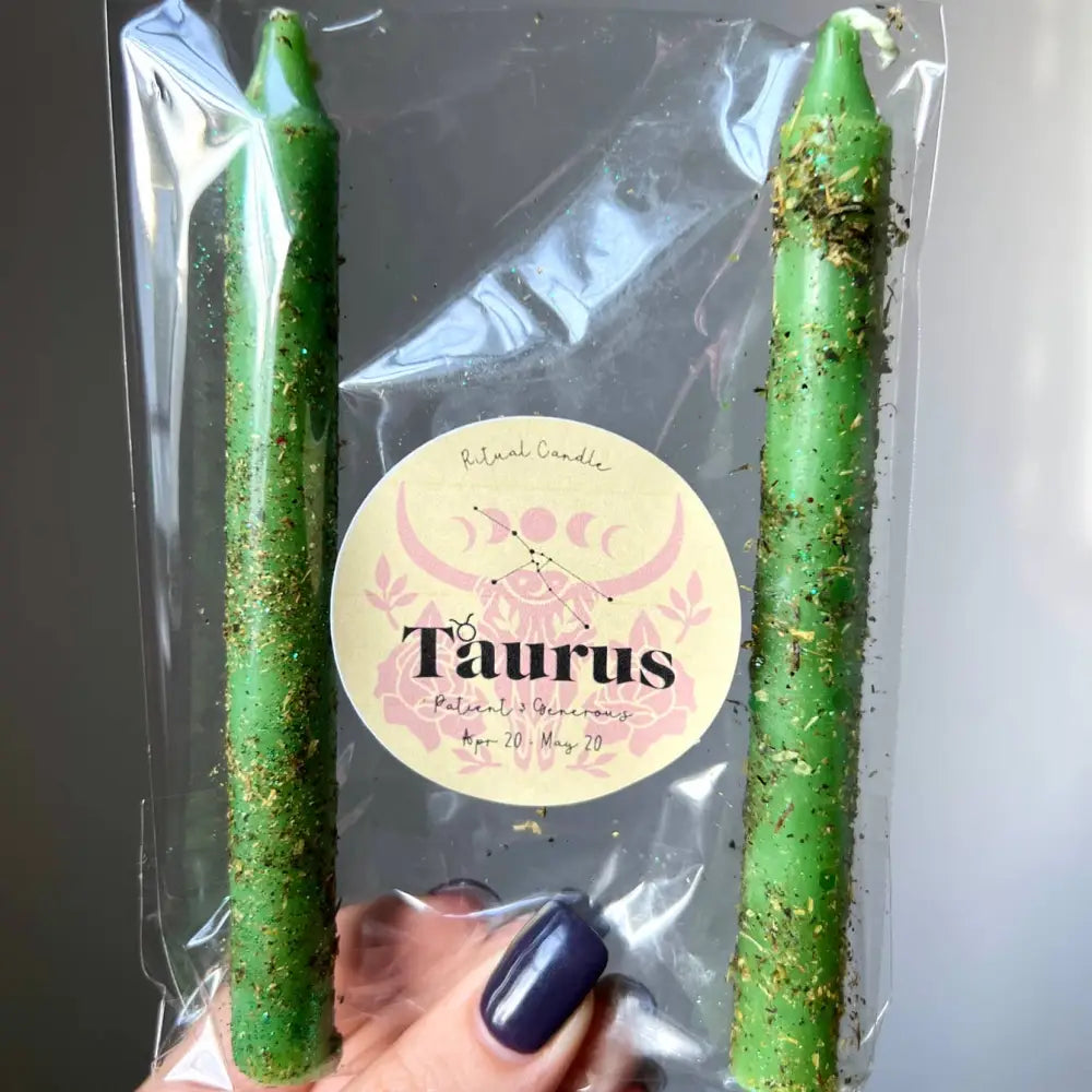 Green glittery Taurus zodiac ritual candle in clear package with gold foil