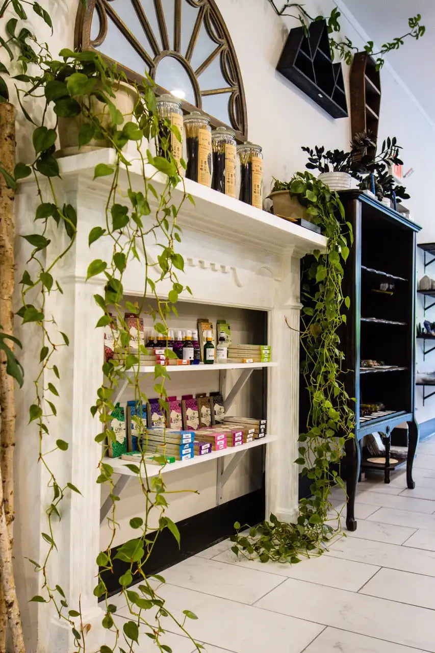 White wooden shelf with glass jars and colorful candies.