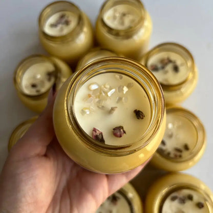 Hand holding golden honeycomb Natural Soy Wax Willow Crystal Jar Candle 8oz with white wax and brown specks