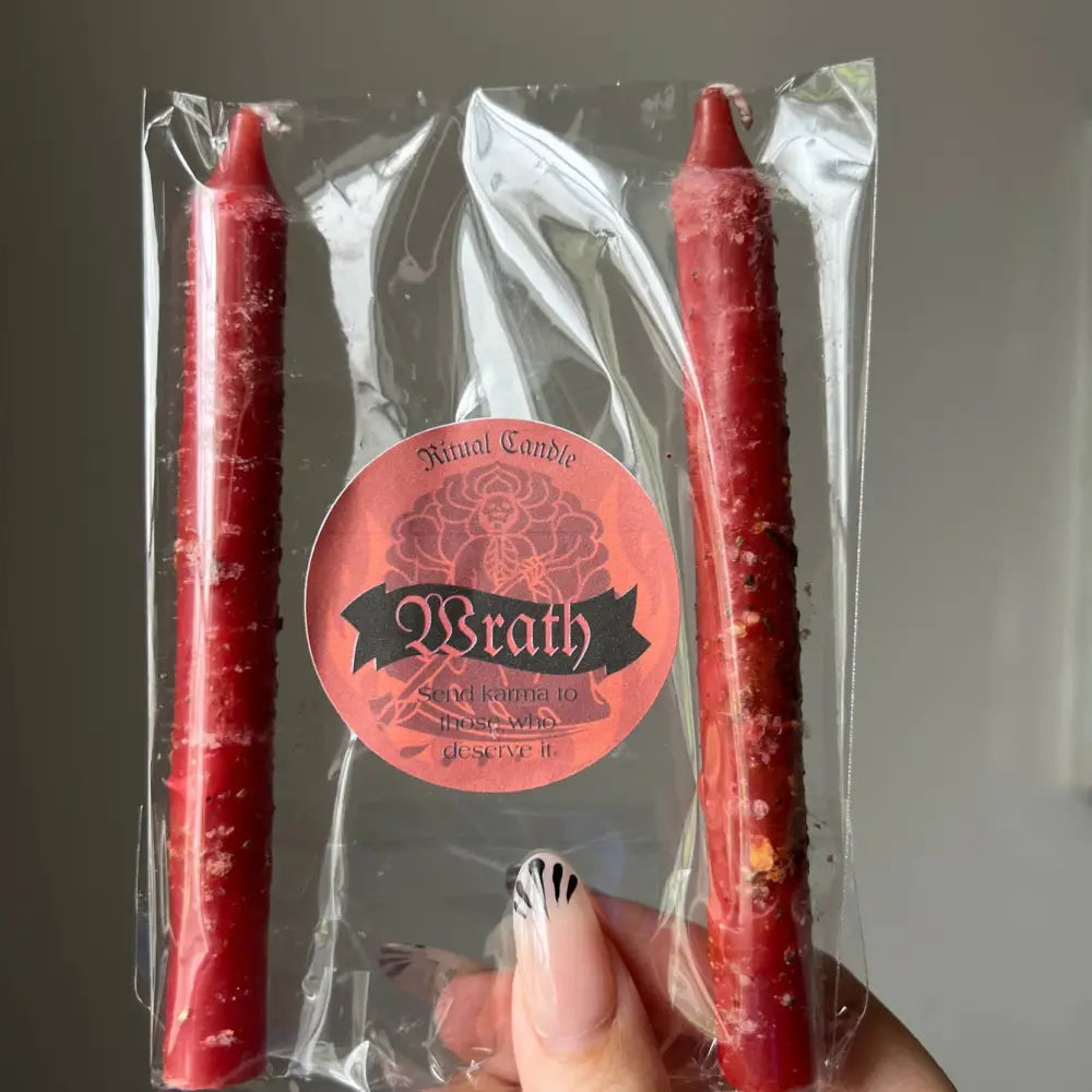 Red Wrath ritual candle in clear plastic pack with herbs and oils