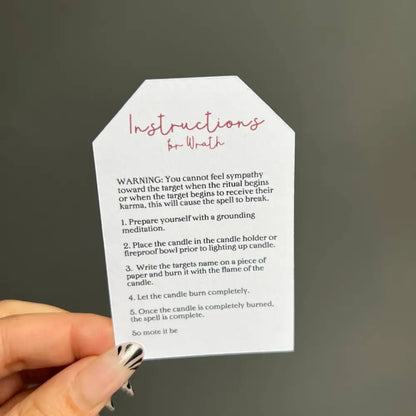 White tag with pink cursive on Wrath Ritual Candle Set