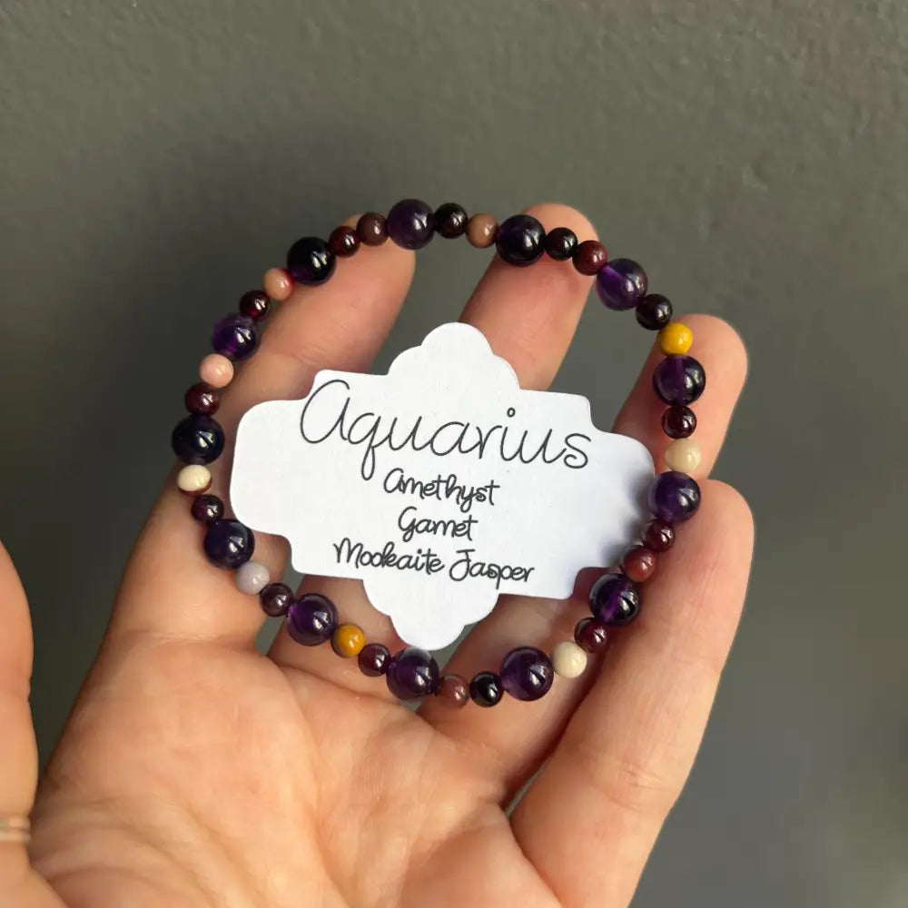 Aquarius zodiac bracelet with amethyst, garnet, and moldavite jasper beads