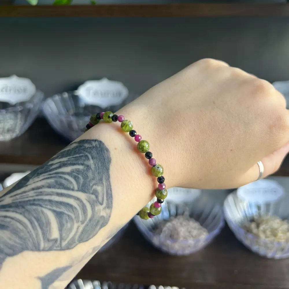 Green and purple Zodiac Crystal Bracelet with black accents